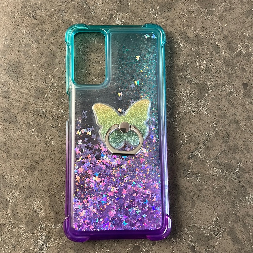 Galaxy Phone 6.75”x3” cover with glitter and butterfly floating inside.